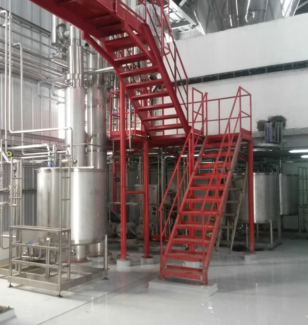 Falling Film evaporator installed in dairy plant — red access staircase